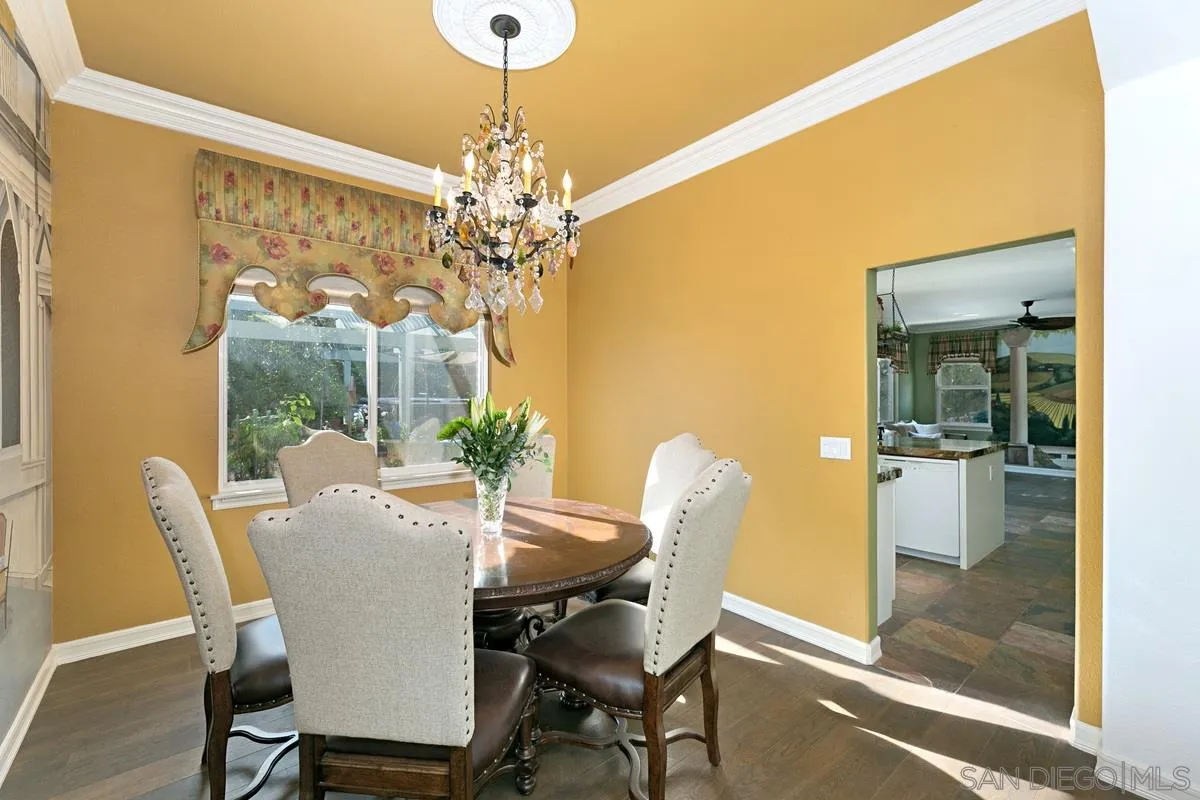 2902 Rancho Rio Chico Carlsbad, CA 92009 - Photo 7 of 30 a view of a dining room with furniture a chandelier and large window