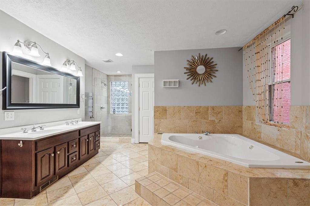 1302 Sarah Street Pittsburgh, PA 15203 - Photo 16 of 25 a spacious bathroom with a tub sink and mirror
