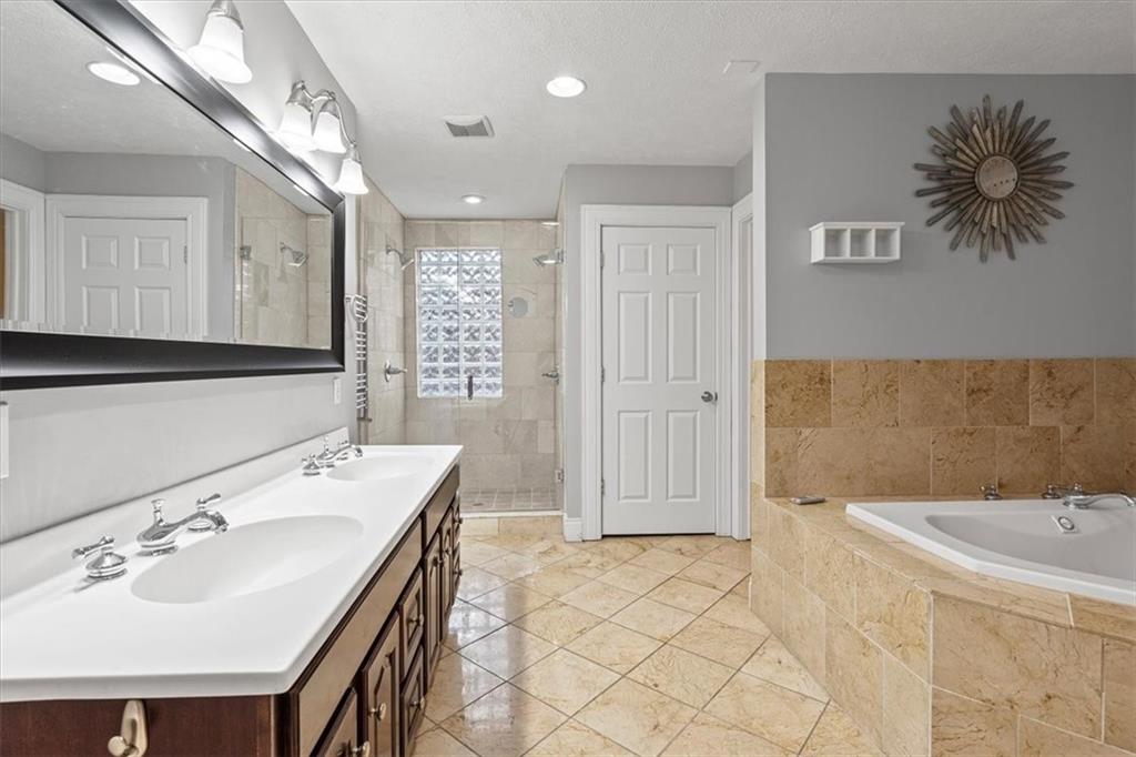1302 Sarah Street Pittsburgh, PA 15203 - Photo 17 of 25 a bathroom with a tub sink and mirror
