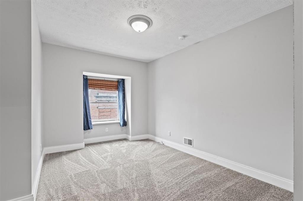 1302 Sarah Street Pittsburgh, PA 15203 - Photo 22 of 25 an empty room with windows