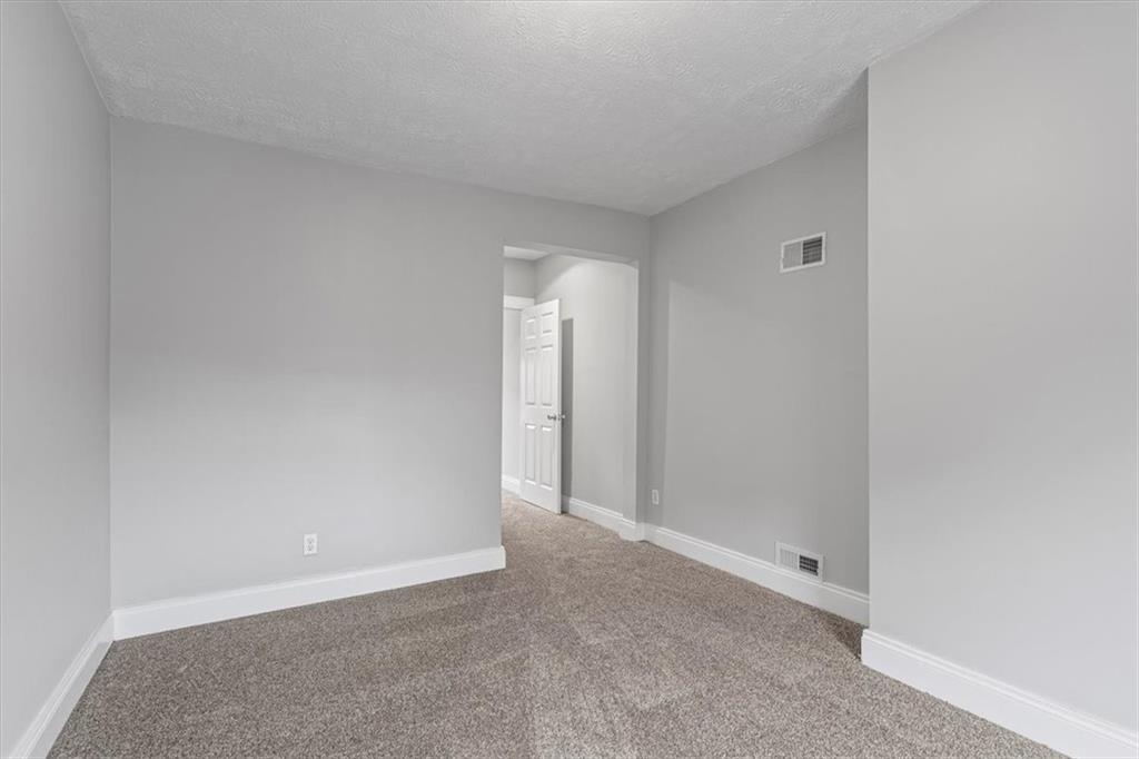 1302 Sarah Street Pittsburgh, PA 15203 - Photo 23 of 25 a view of an empty room with closet and mirror
