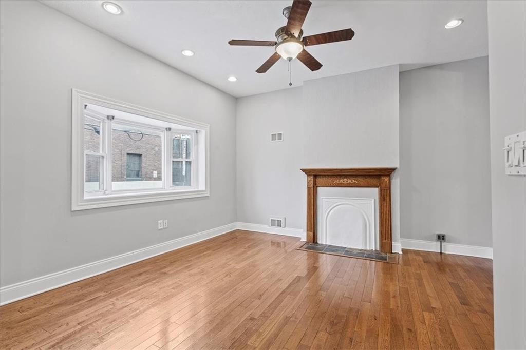 1302 Sarah Street Pittsburgh, PA 15203 - Photo 5 of 25 a view of empty room with wooden floor and fan