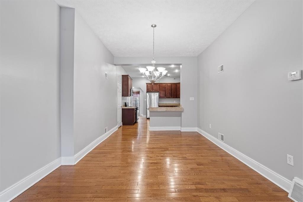 1302 Sarah Street Pittsburgh, PA 15203 - Photo 7 of 25 a view of a room with wooden floor kitchen and window