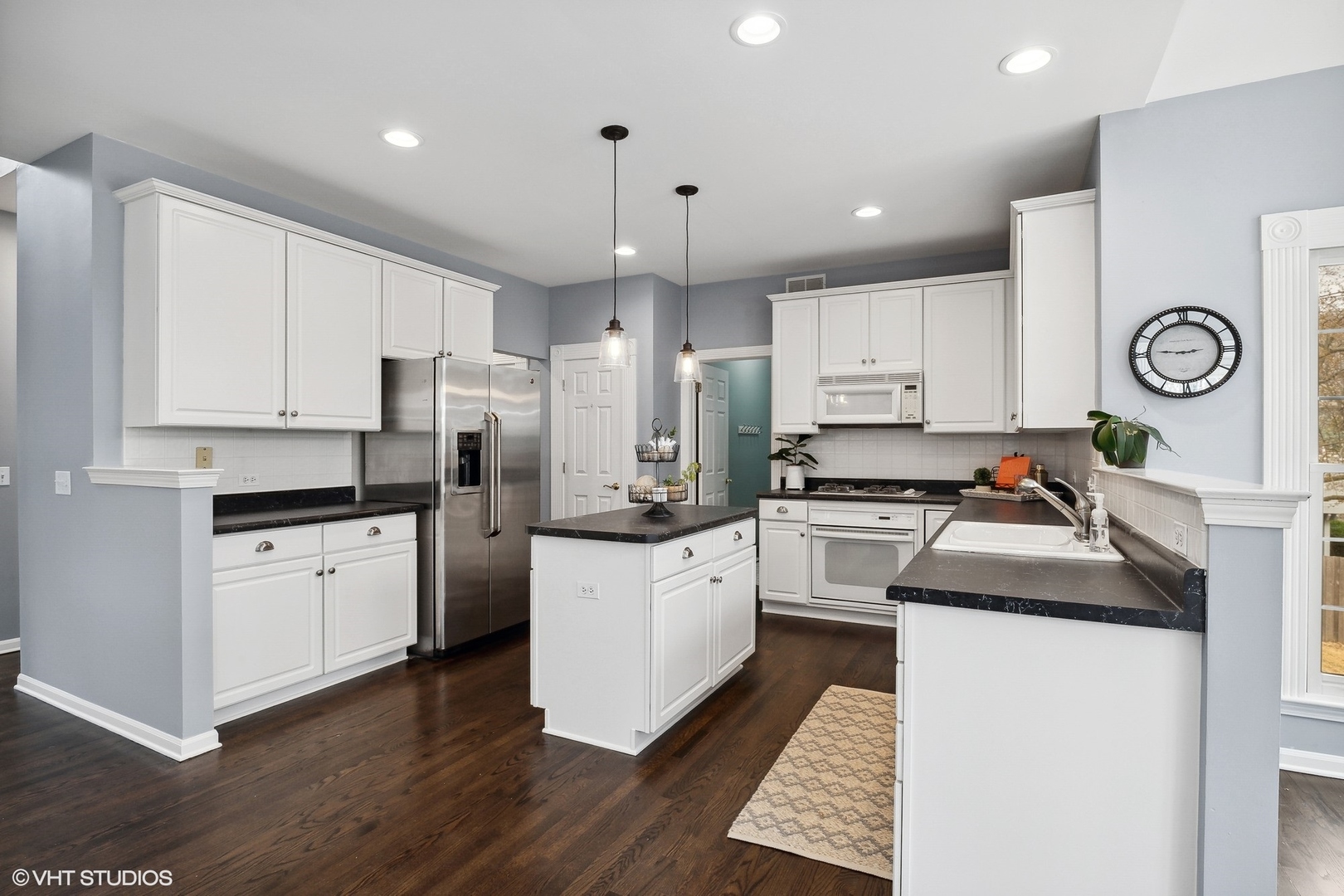 665 Angelo Avenue Gurnee, IL 60031 - Photo 6 of 34 a kitchen with granite countertop white cabinets and white appliances