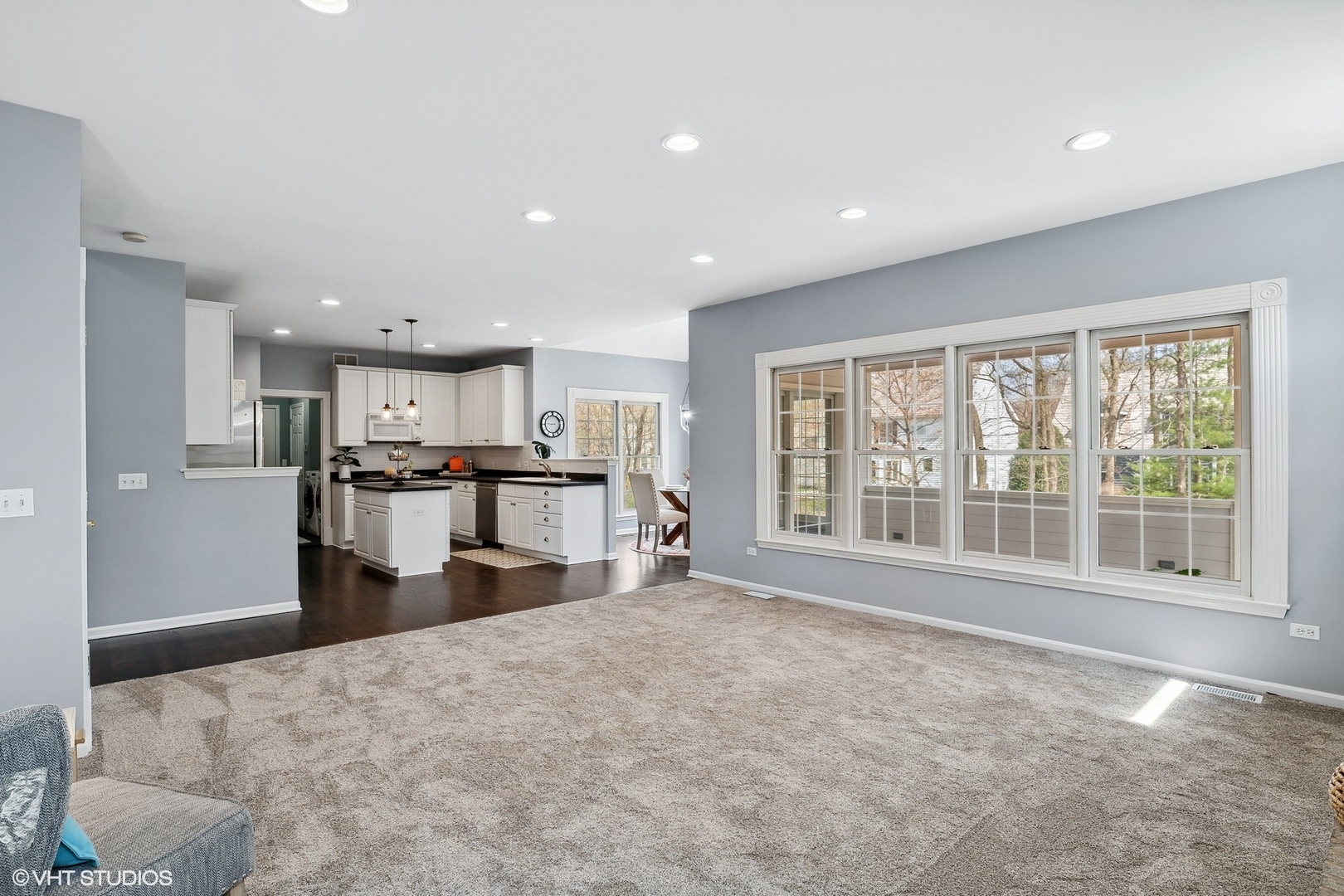 665 Angelo Avenue Gurnee, IL 60031 - Photo 7 of 34 a large kitchen with kitchen island a stove a refrigerator a sink a dining table and chairs
