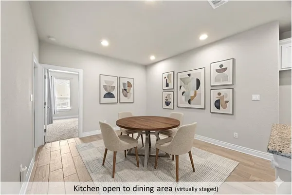 a living room with a table and a painting on the wall