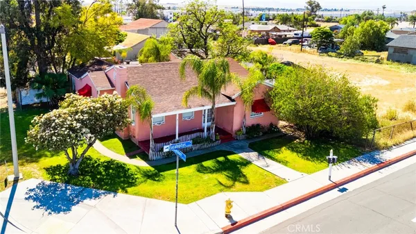 an aerial view of residential houses with yard and swimming pool