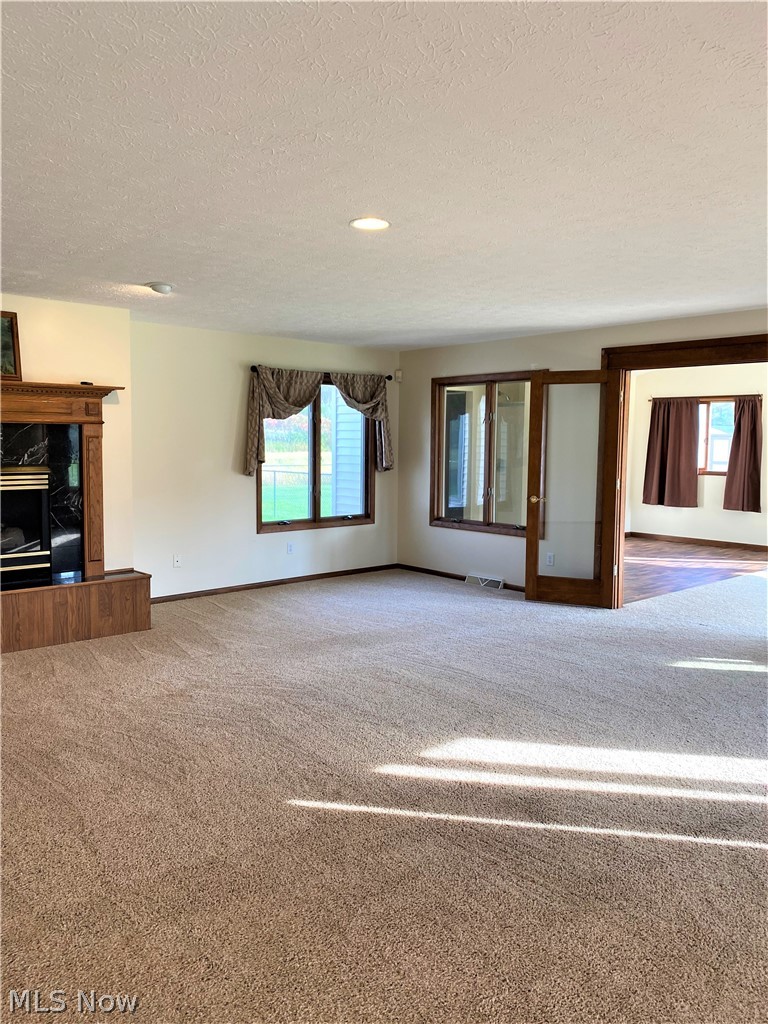 7682 Sanborn Road Ashtabula, OH 44004 - Photo 11 of 35 Great room 23 x 22 with gas fireplace and leads to the all year sunroom.