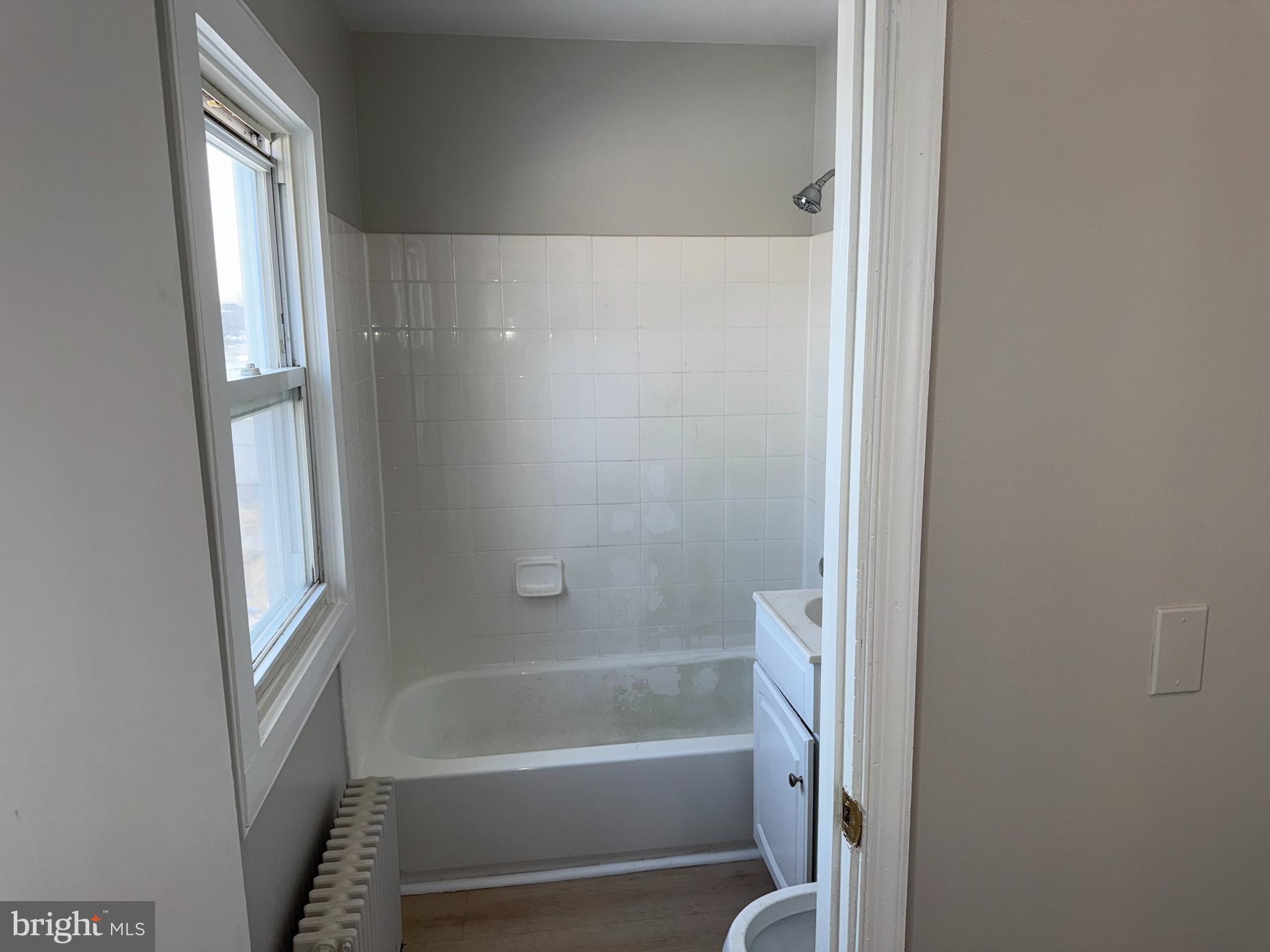 706 Chain Street, Unit 3 Norristown, PA 19401 - Photo 11 of 15 a bathroom with a bathtub and a shower