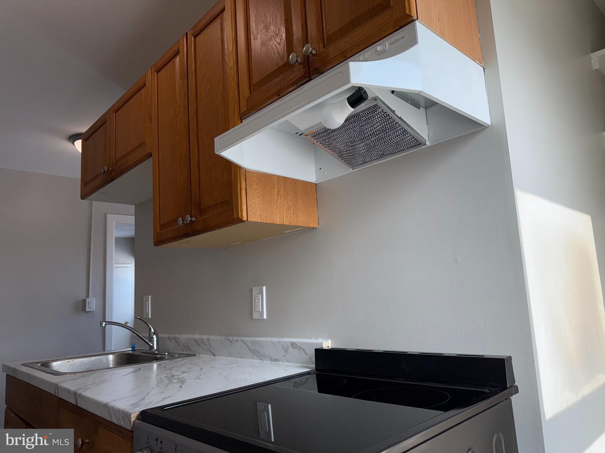 706 Chain Street, Unit 3 Norristown, PA 19401 - Photo 7 of 15 a kitchen with a sink cabinets and wooden floor