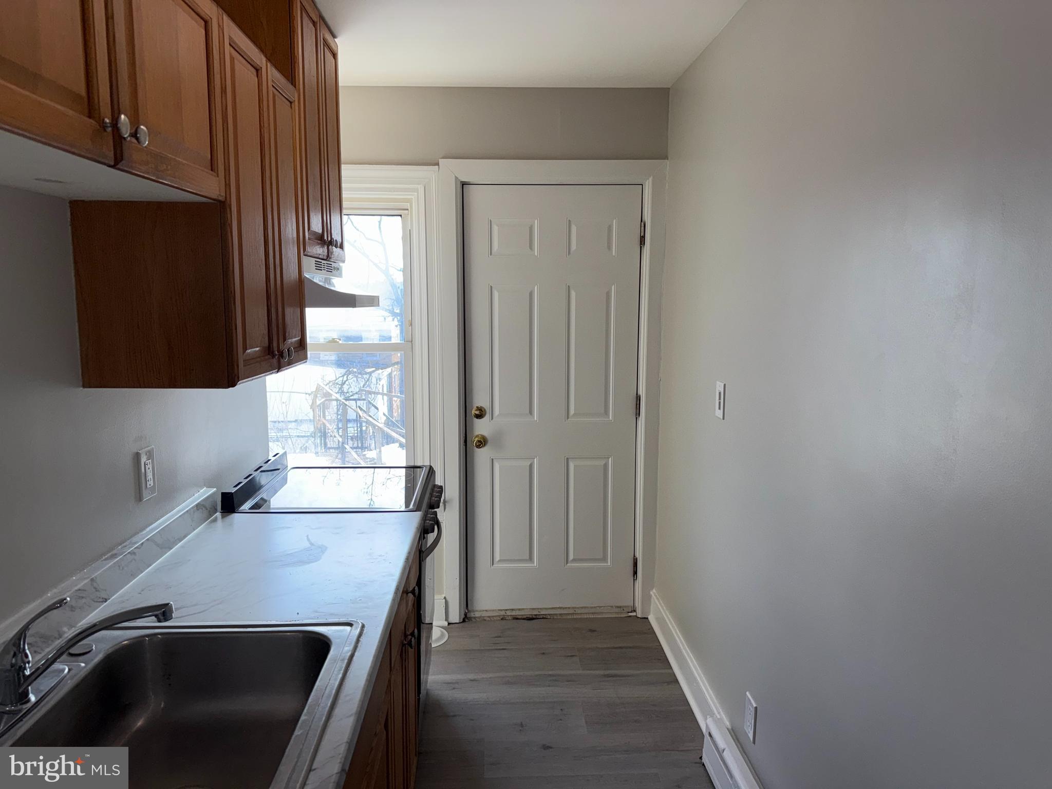 706 Chain Street, Unit 3 Norristown, PA 19401 - Photo 8 of 15 a view of a room with wooden floor and cabinet