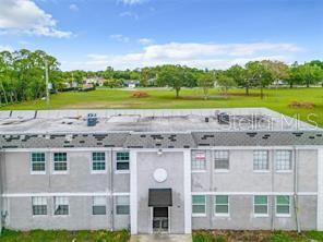 an aerial view of a house with a yard and lake view