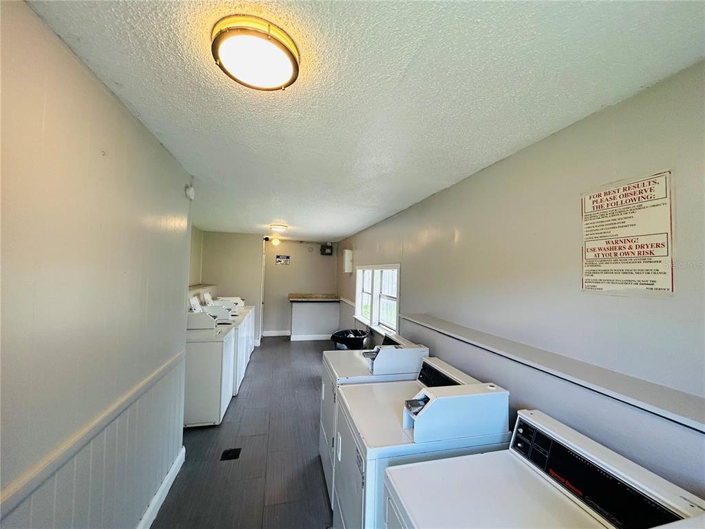 2771 L B McLeod Road, Unit A Orlando, FL 32805 - Photo 16 of 17 a hallway with a couch and chandelier