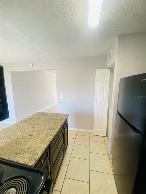 2771 L B McLeod Road, Unit A Orlando, FL 32805 - Photo 7 of 17 a kitchen with a stove and a refrigerator