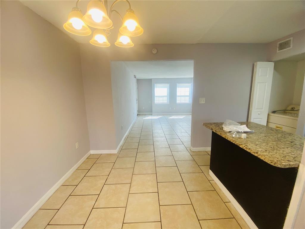 2771 L B McLeod Road, Unit A Orlando, FL 32805 - Photo 9 of 17 a bathroom with a granite countertop sink a toilet and a mirror