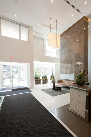 a living room with furniture pool table and a large window