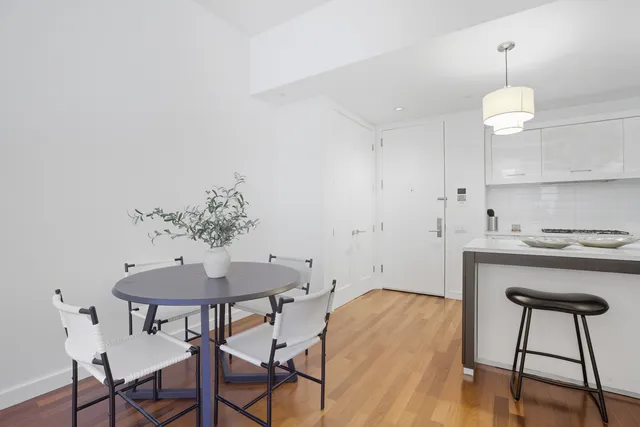 a kitchen with a table and chairs in it