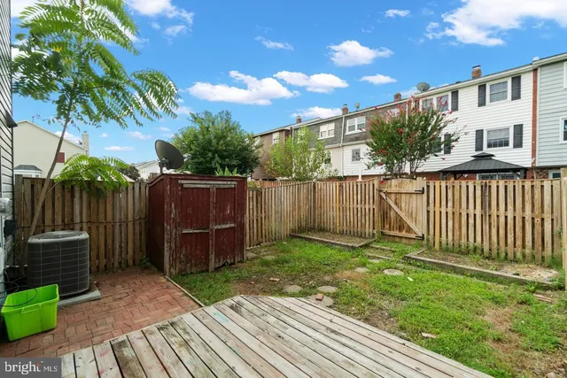 a view of a backyard with wooden fence