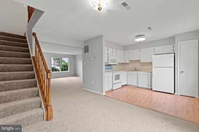 a view of kitchen with refrigerator and microwave