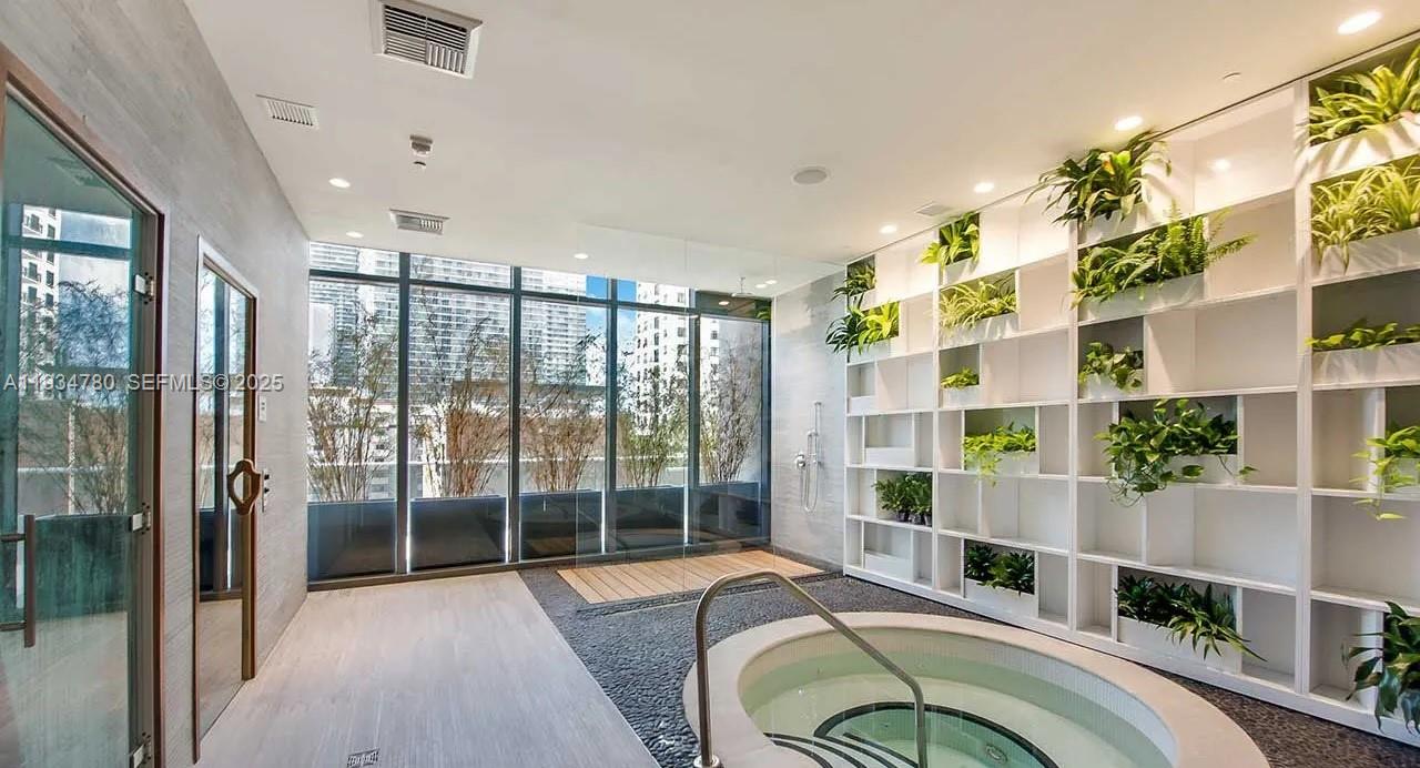 45 Southwest 9th Street, Unit 3210 Miami, FL 33130 - Photo 16 of 20 a bedroom with furniture and a large window