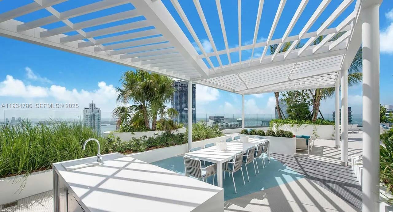 45 Southwest 9th Street, Unit 3210 Miami, FL 33130 - Photo 18 of 20 a view of a patio with a table chairs and a patio