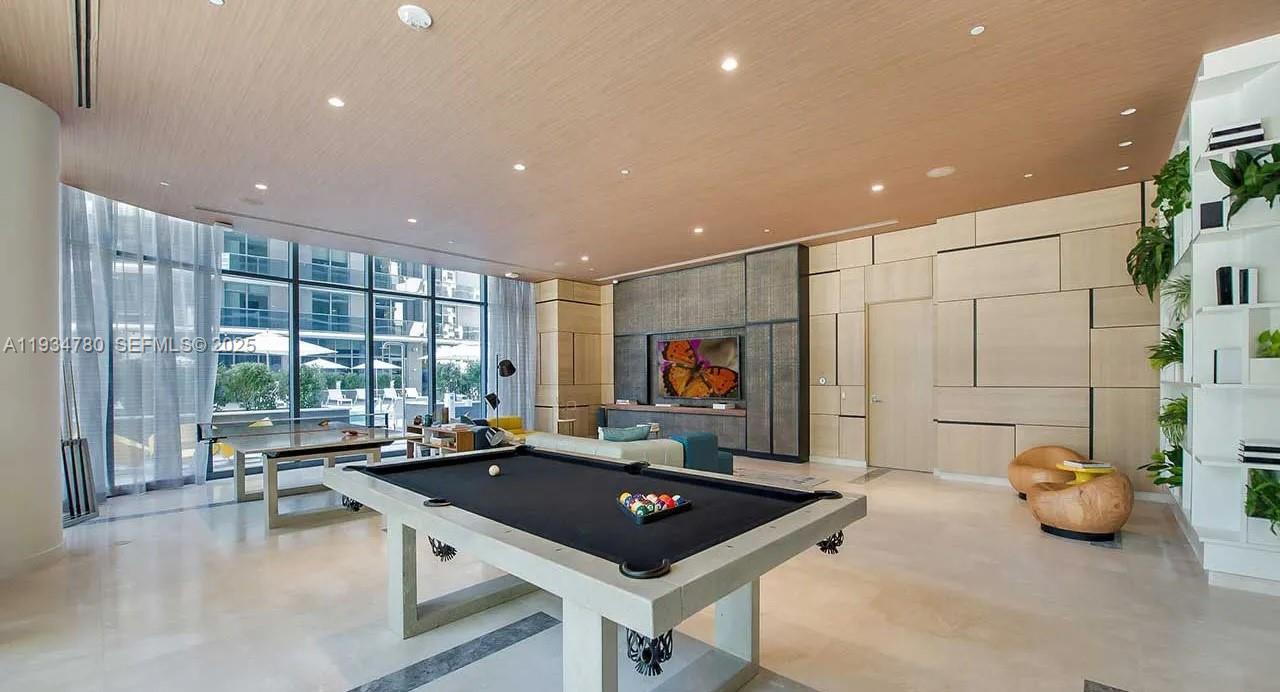 45 Southwest 9th Street, Unit 3210 Miami, FL 33130 - Photo 19 of 20 a living room with furniture a flat screen tv and a large window