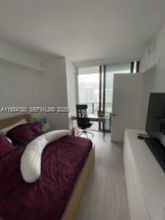 45 Southwest 9th Street, Unit 3210 Miami, FL 33130 - Photo 4 of 20 a spacious bedroom with a bed and wooden floor