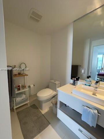 45 Southwest 9th Street, Unit 3210 Miami, FL 33130 - Photo 6 of 20 a bathroom with a sink a toilet and vanity