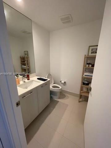 45 Southwest 9th Street, Unit 3210 Miami, FL 33130 - Photo 7 of 20 a bathroom with a sink mirror vanity and toilet