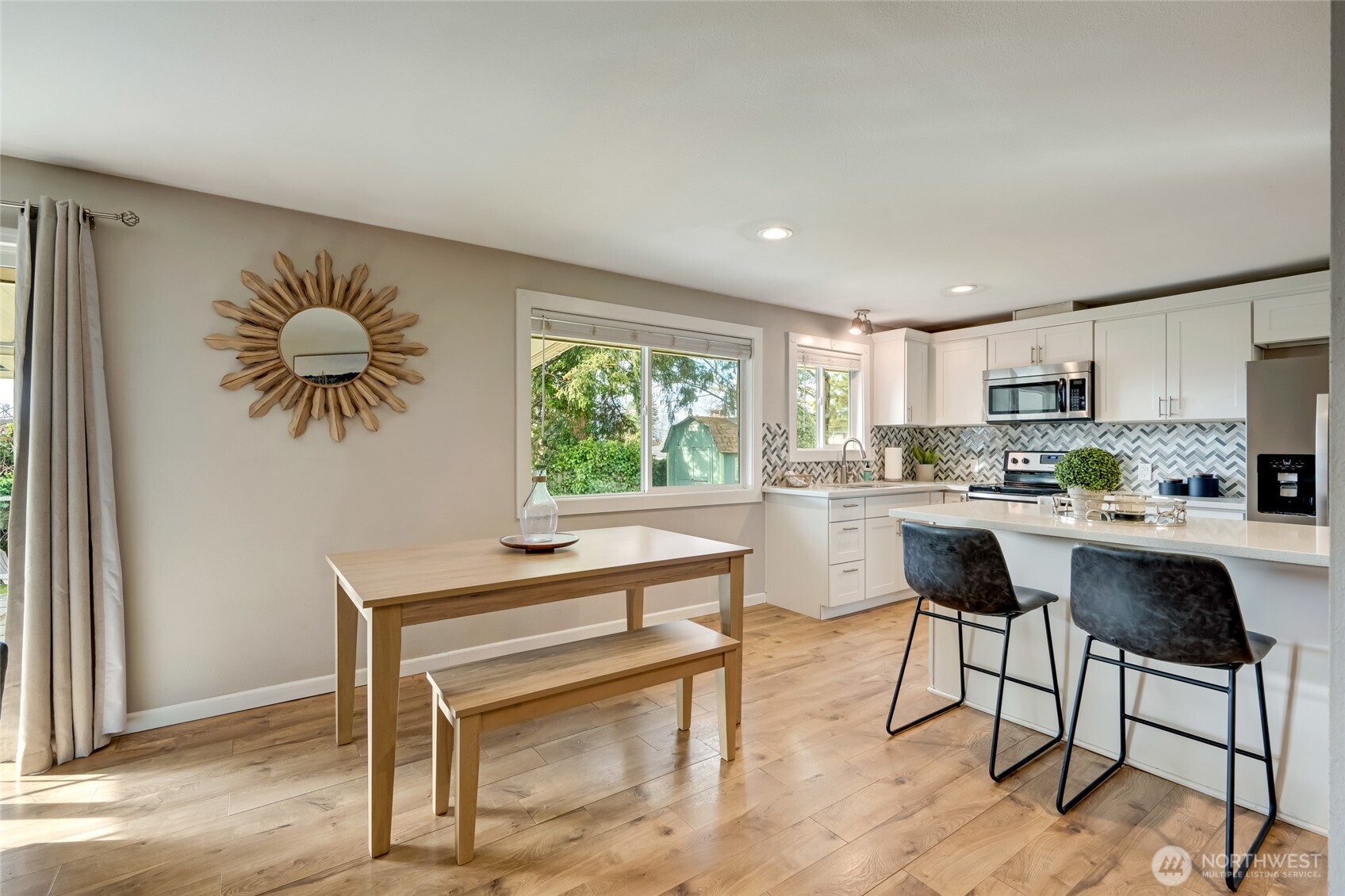 825 Index Court Northeast Renton, WA 98056 - Photo 13 of 40 a kitchen with a table chairs refrigerator and cabinets