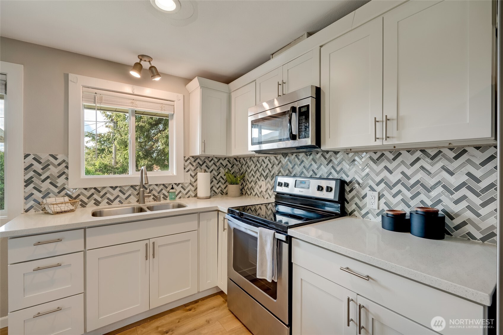 825 Index Court Northeast Renton, WA 98056 - Photo 18 of 40 a kitchen with a sink stove and microwave
