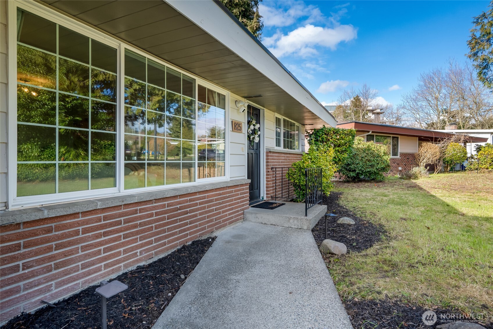 825 Index Court Northeast Renton, WA 98056 - Photo 2 of 40 a view of house with backyard and glass windows
