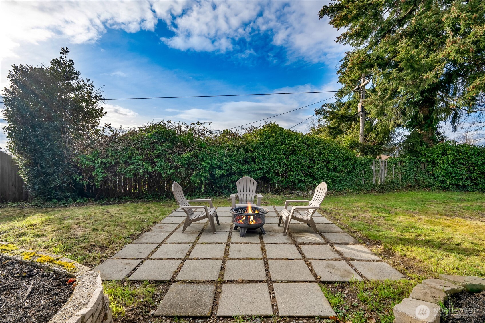 825 Index Court Northeast Renton, WA 98056 - Photo 32 of 40 a view of a patio with lawn chairs under an umbrella