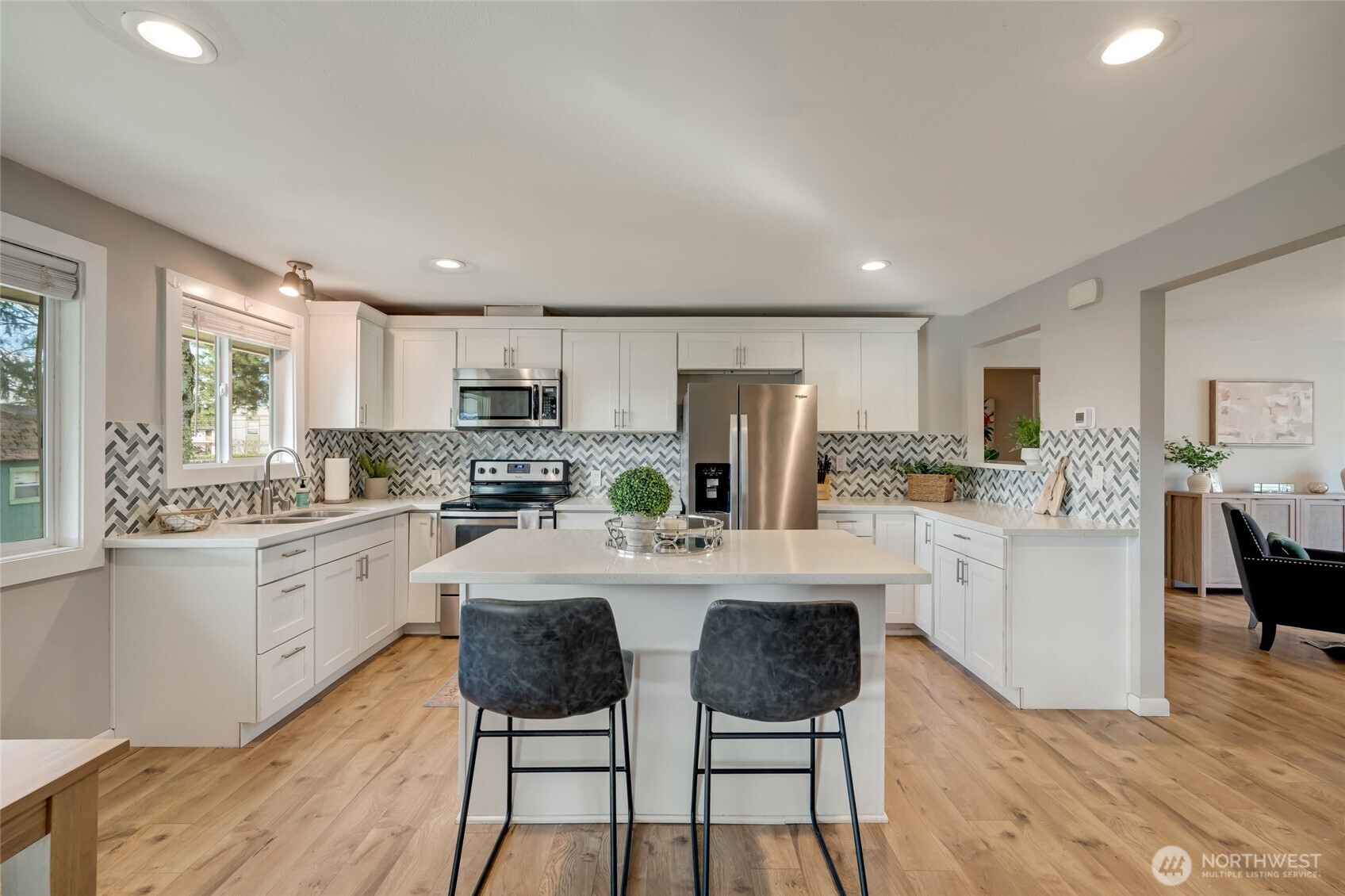 825 Index Court Northeast Renton, WA 98056 - Photo 7 of 40 a kitchen with white cabinets and stainless steel appliances