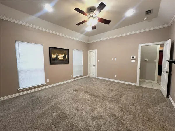 a view of an empty room and a ceiling fan