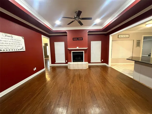 a view of an empty room with a fireplace and a window