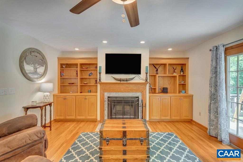 6863 Amicus Road Ruckersville, VA 22968 - Photo 12 of 42 a living room with fireplace furniture and a flat screen tv