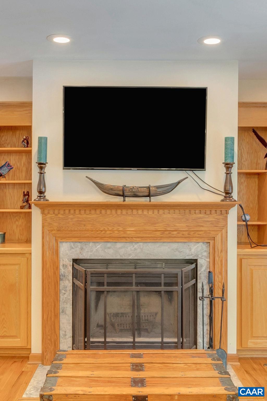 6863 Amicus Road Ruckersville, VA 22968 - Photo 13 of 42 a living room with a fireplace and a flat screen tv