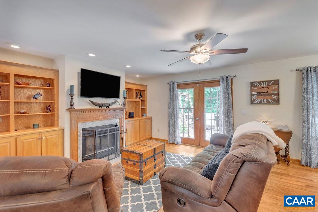 6863 Amicus Road Ruckersville, VA 22968 - Photo 16 of 42 a living room with furniture a fireplace and a flat screen tv