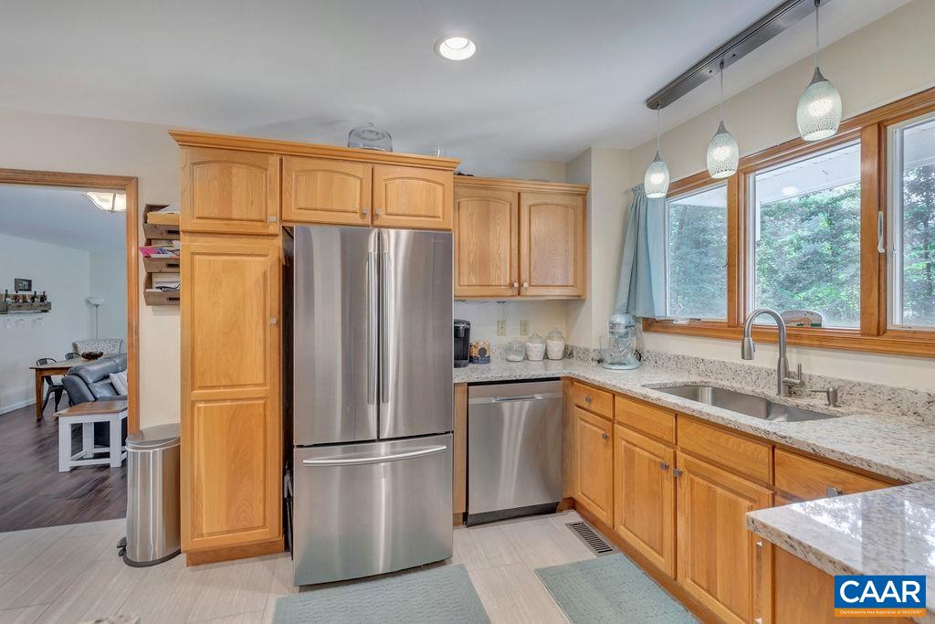6863 Amicus Road Ruckersville, VA 22968 - Photo 3 of 42 a kitchen with stainless steel appliances granite countertop a refrigerator a sink and a stove