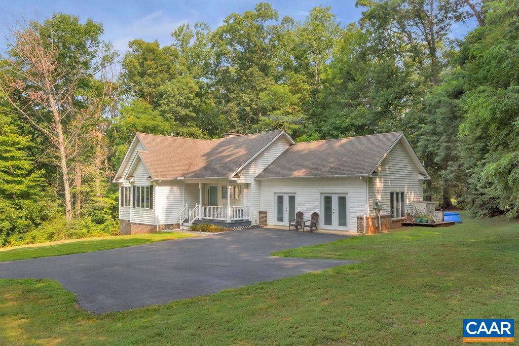 6863 Amicus Road Ruckersville, VA 22968 - Photo 31 of 42 a front view of a house with a garden and trees