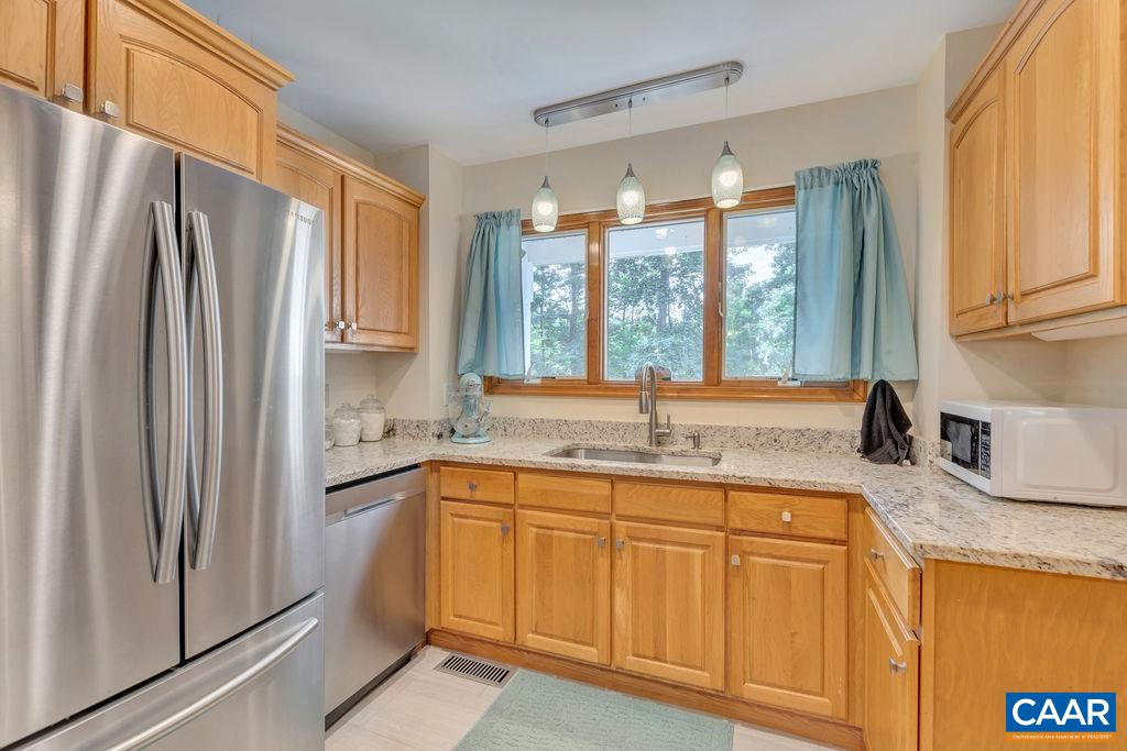6863 Amicus Road Ruckersville, VA 22968 - Photo 4 of 42 a kitchen with stainless steel appliances granite countertop a refrigerator and a sink