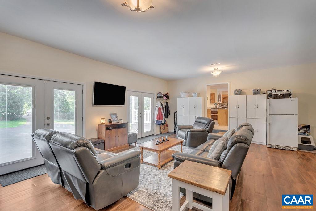 6863 Amicus Road Ruckersville, VA 22968 - Photo 9 of 42 a living room with furniture and a flat screen tv