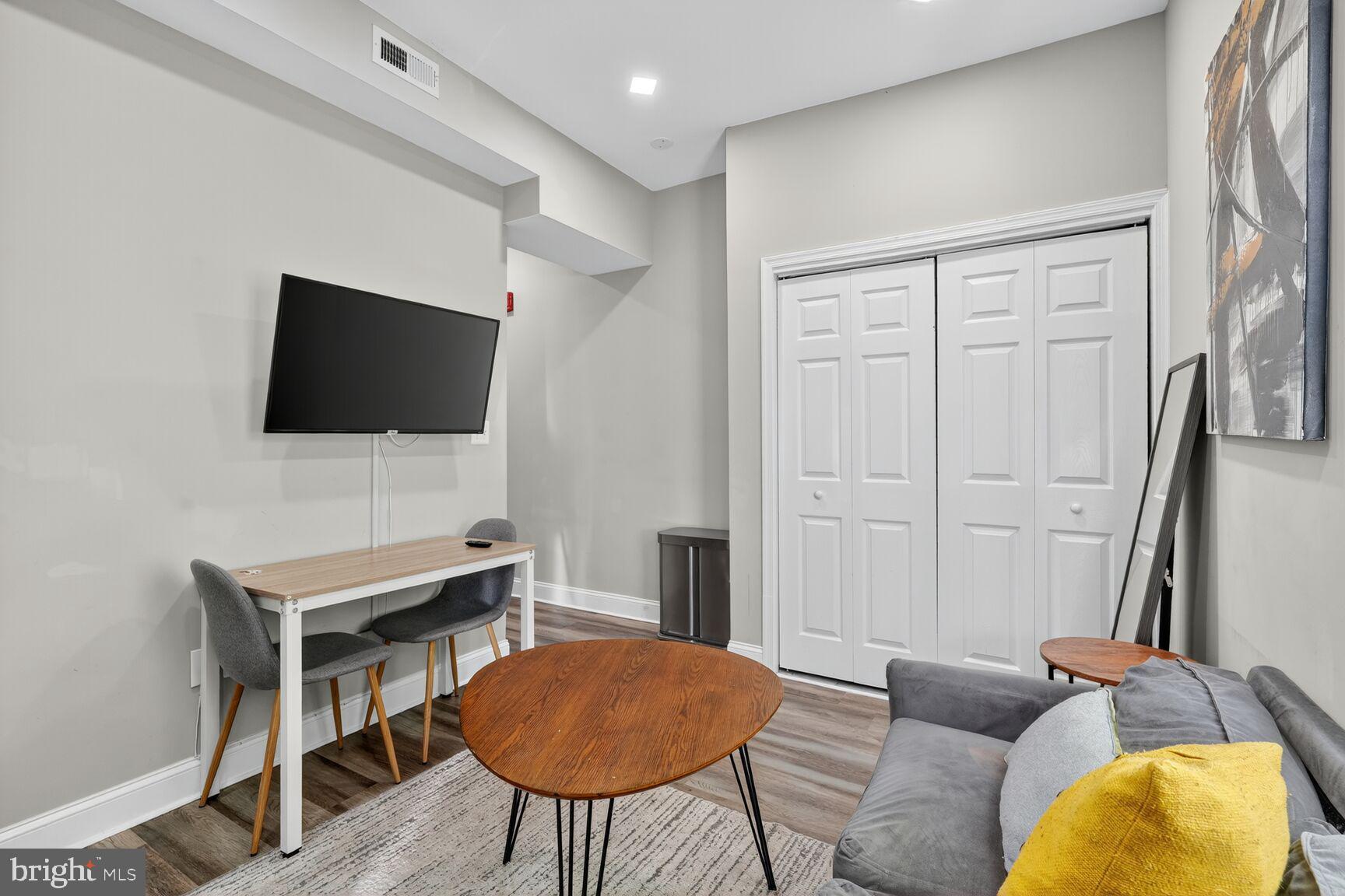 133 7th Street Southeast, Unit 10 Washington, DC 20003 - Photo 9 of 14 a living room with furniture and a flat screen tv