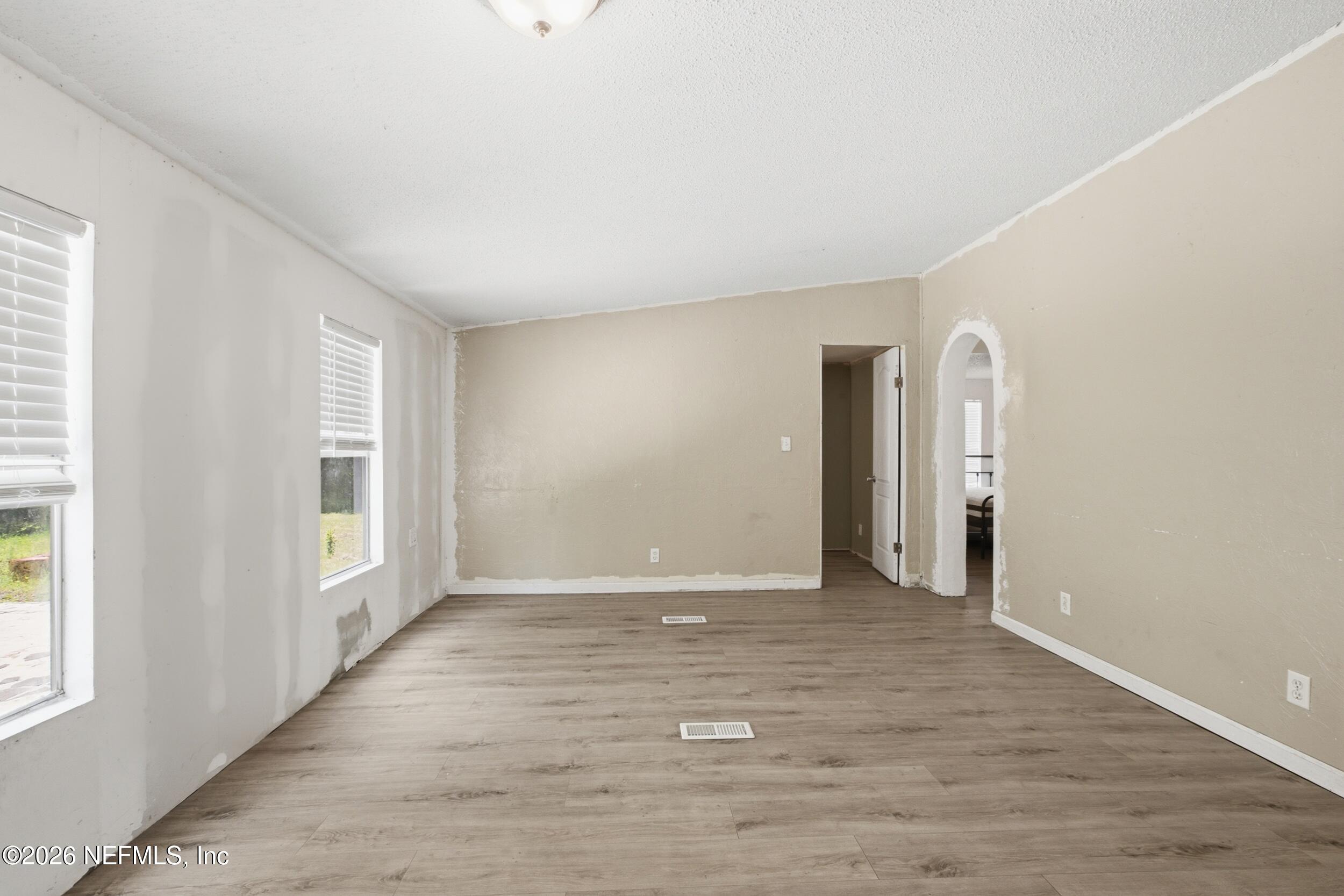 5667 Long Branch Cemetery Road Jacksonville, FL 32234 - Photo 14 of 24 a view of an empty room with wooden floor and a window