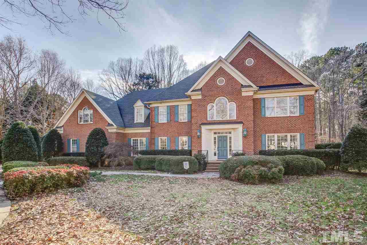 Brick Home with side entry 3 car garage on a private corner lot.
