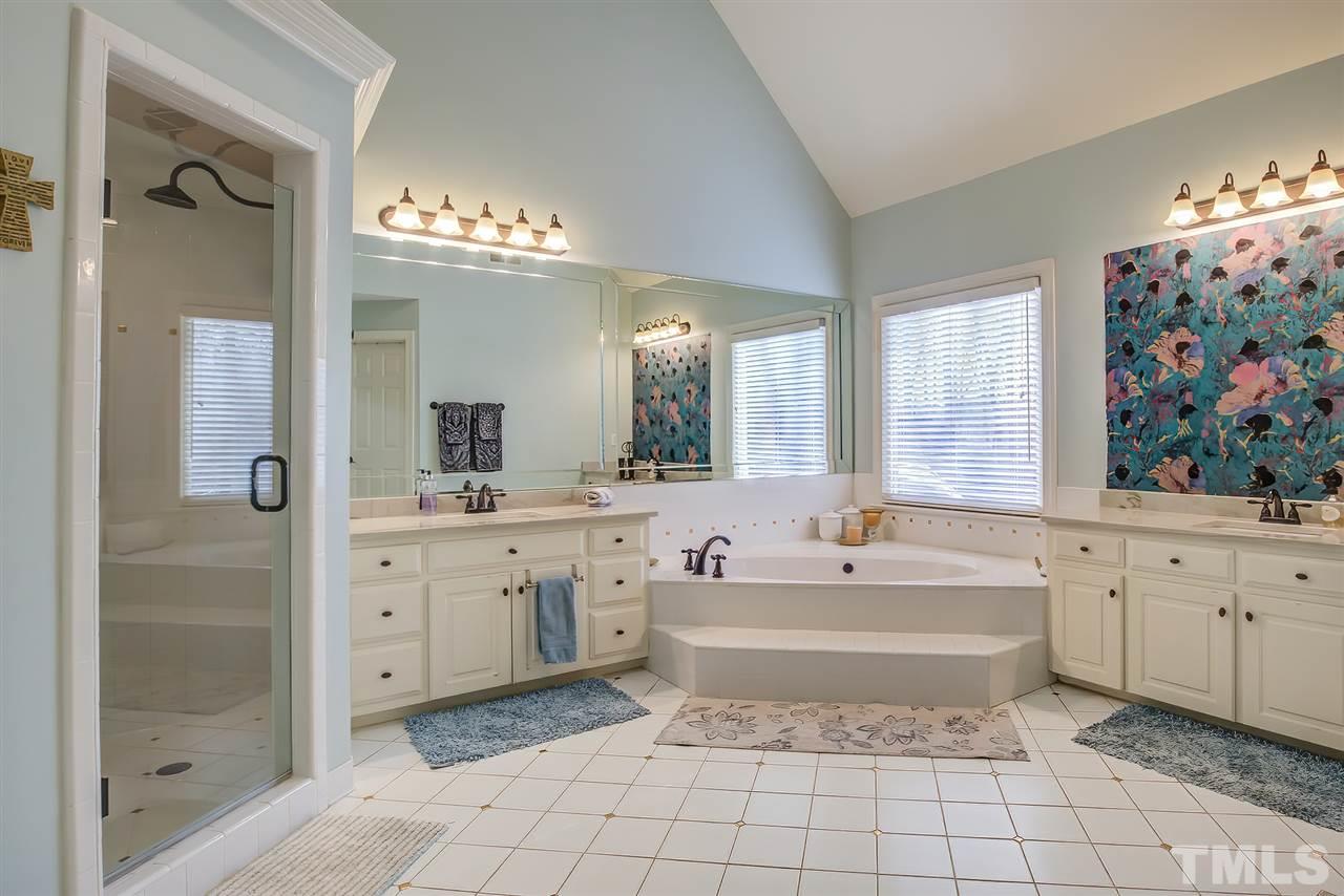 12129 Lockhart Lane Raleigh, NC 27614 - Photo 17 of 30 Large master bath with seperate dual vanities, a tiled shower, separate soaking tub and two walk in closets. WC as well.