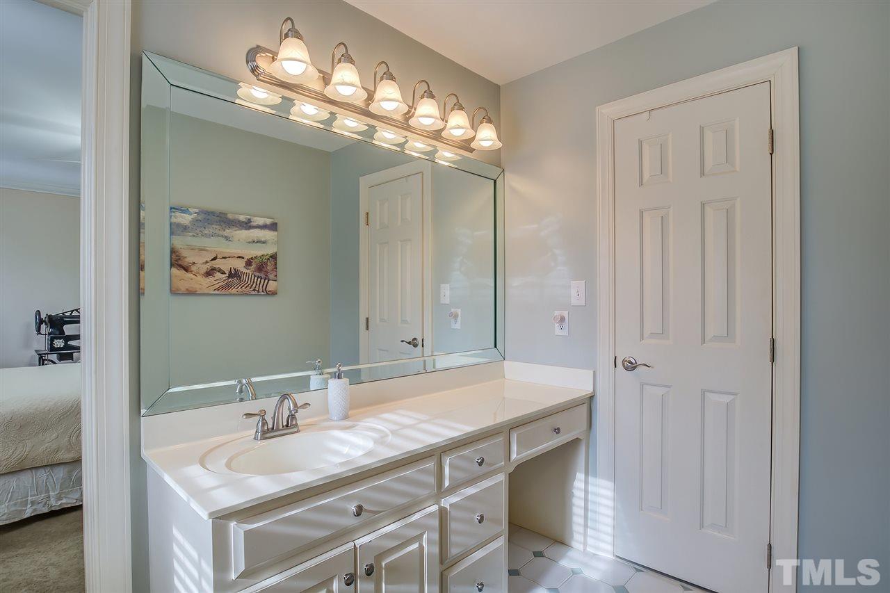 12129 Lockhart Lane Raleigh, NC 27614 - Photo 20 of 30 Large guest bath with one vanity and a separate cabinet with countertop.