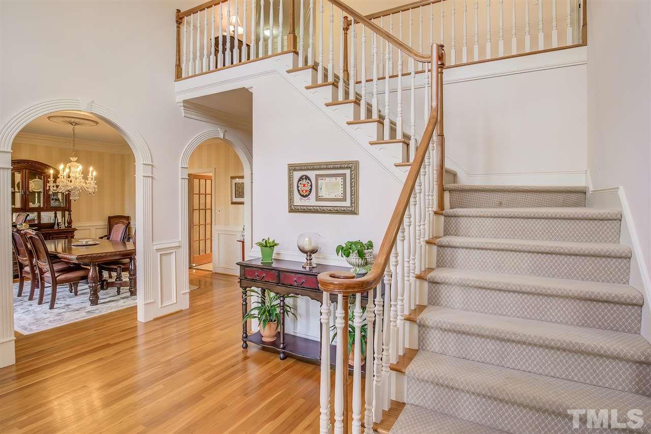 Beautiful light filled entry foyer with soaring ceiling and access to the living room and dining room. Open staircase. Harwood floors.