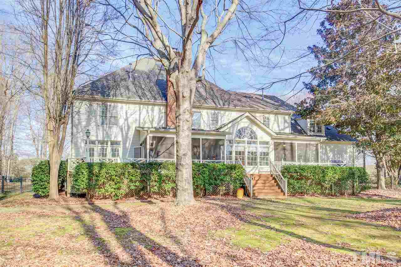 12129 Lockhart Lane Raleigh, NC 27614 - Photo 29 of 30 Large backyard with trees and black metal fence.